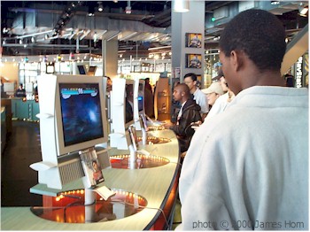 Gamers try out the latest fighting games at the PlayStation store.